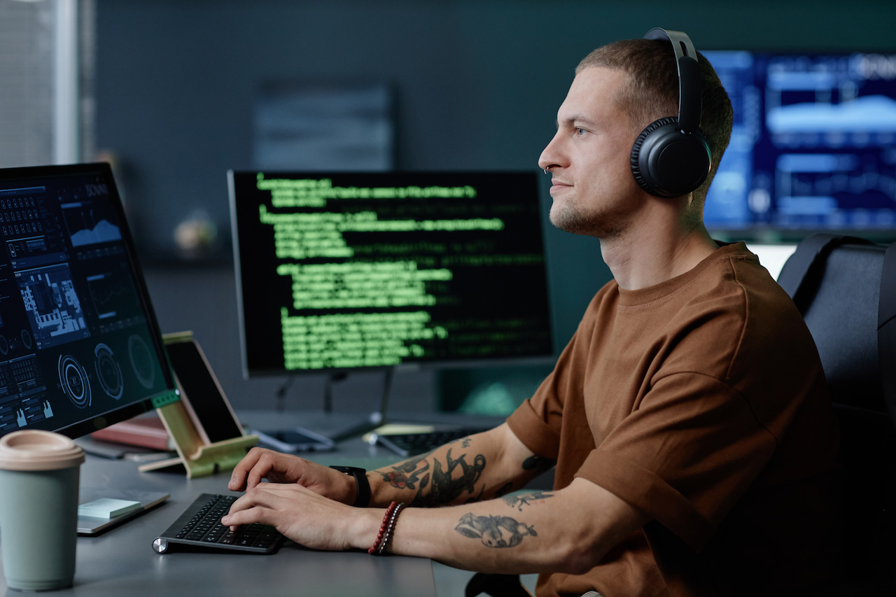 A developer in headphones working through code