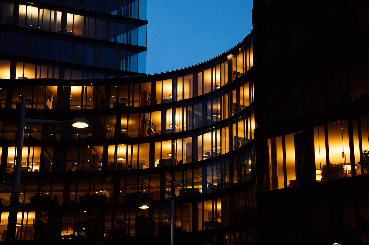 An office building at night with its windows lit
