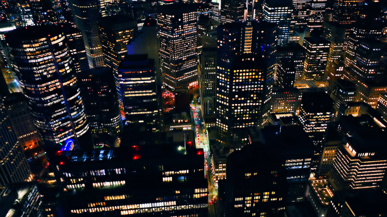Lit office towers in San Francisco at night, seen from above