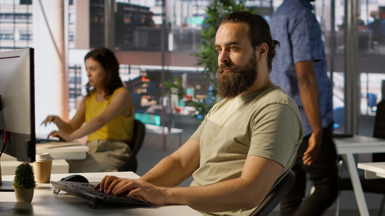 People working at computers in a bright office